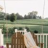 Hanging Wooden Porch Swing on the deck of a House