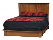 A wooden bed frame with a matress and pillows
