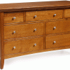 A wooden dresser with multiple drawers