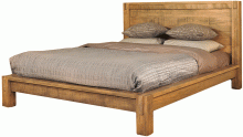 A wooden bed frame with a mattress and pillows