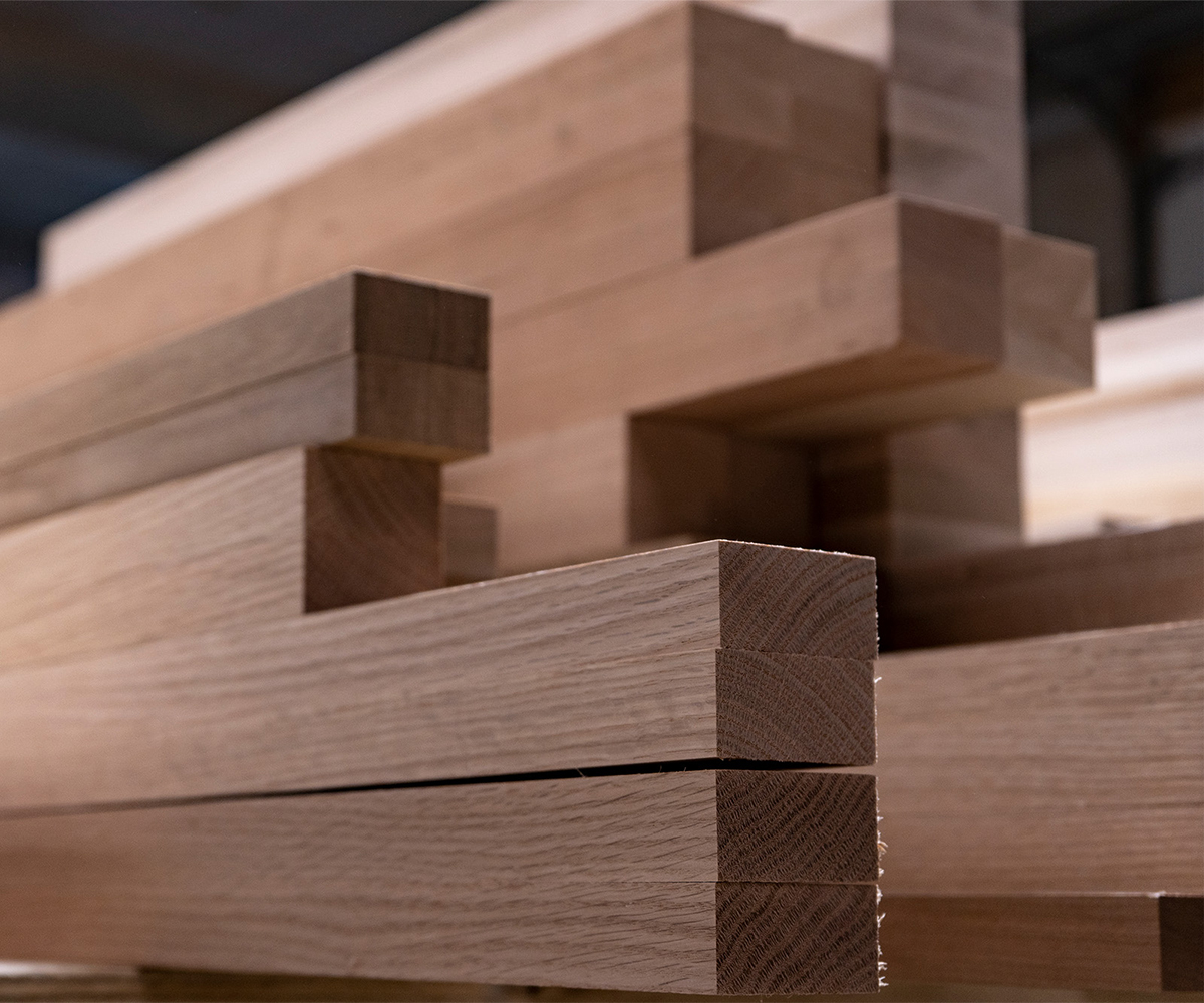 Stack of smooth hardwood boards ready for crafting solid wood furniture pieces.