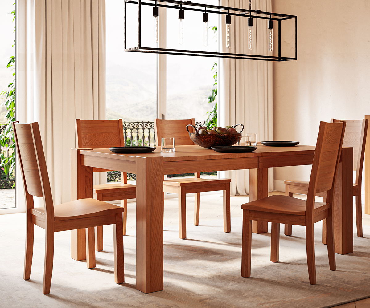 Light-stained Amish dining table and chairs in sunny room with large windows and curtains.