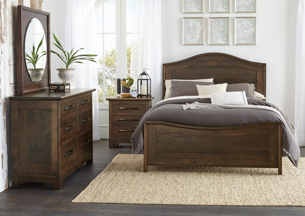 A rustic bedroom featuring dark wood furniture, including a bed with built-in storage, a dresser with multiple drawers, and a nightstand for additional organization. The neatly arranged decor, baskets, and bedside accessories showcase smart storage and organization ideas for a cozy, clutter-free space.